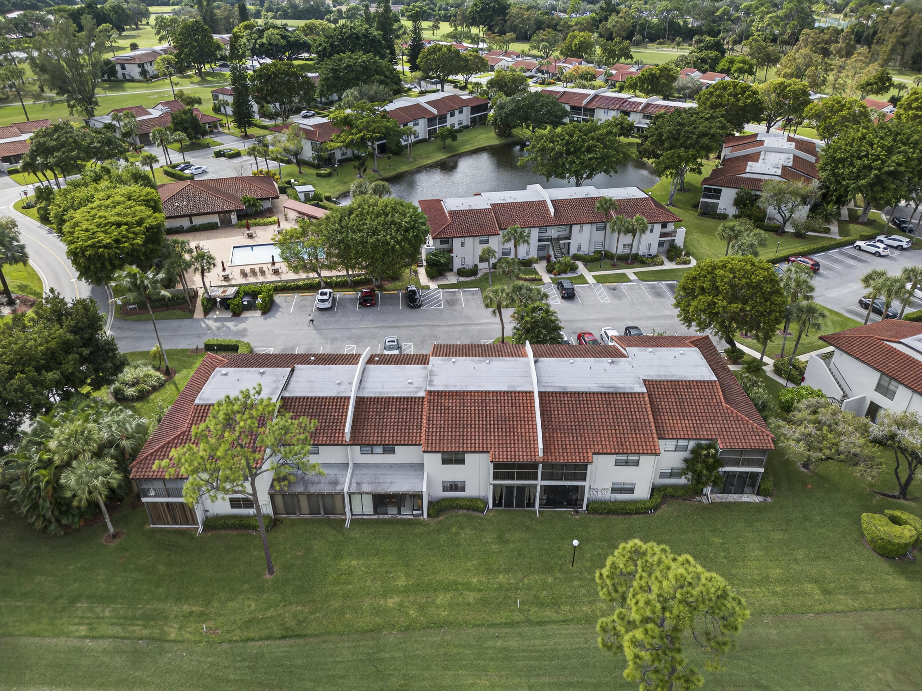 9187 Norte Lago, Unit 5I Boca Raton, FL 33428 - Photo 36 of 37 an aerial view of residential houses with outdoor space and swimming pool