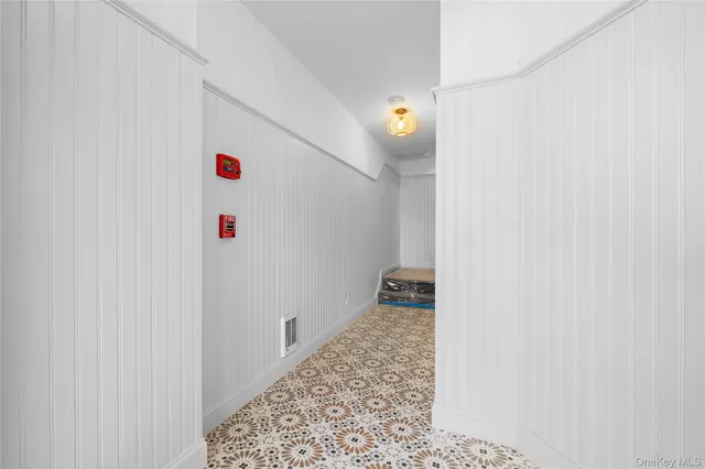 a view of a hallway to a house and wooden floor