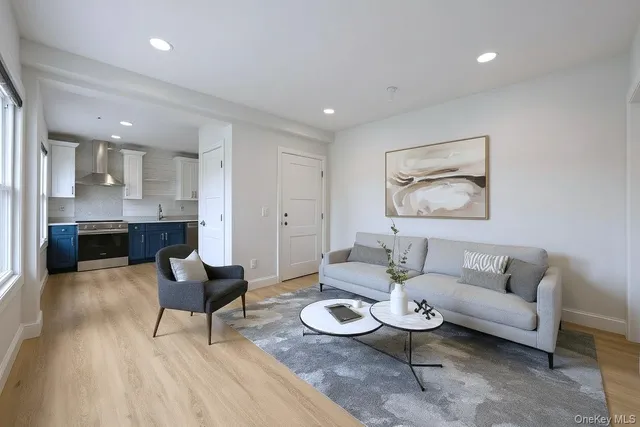 a living room with furniture and a dining table