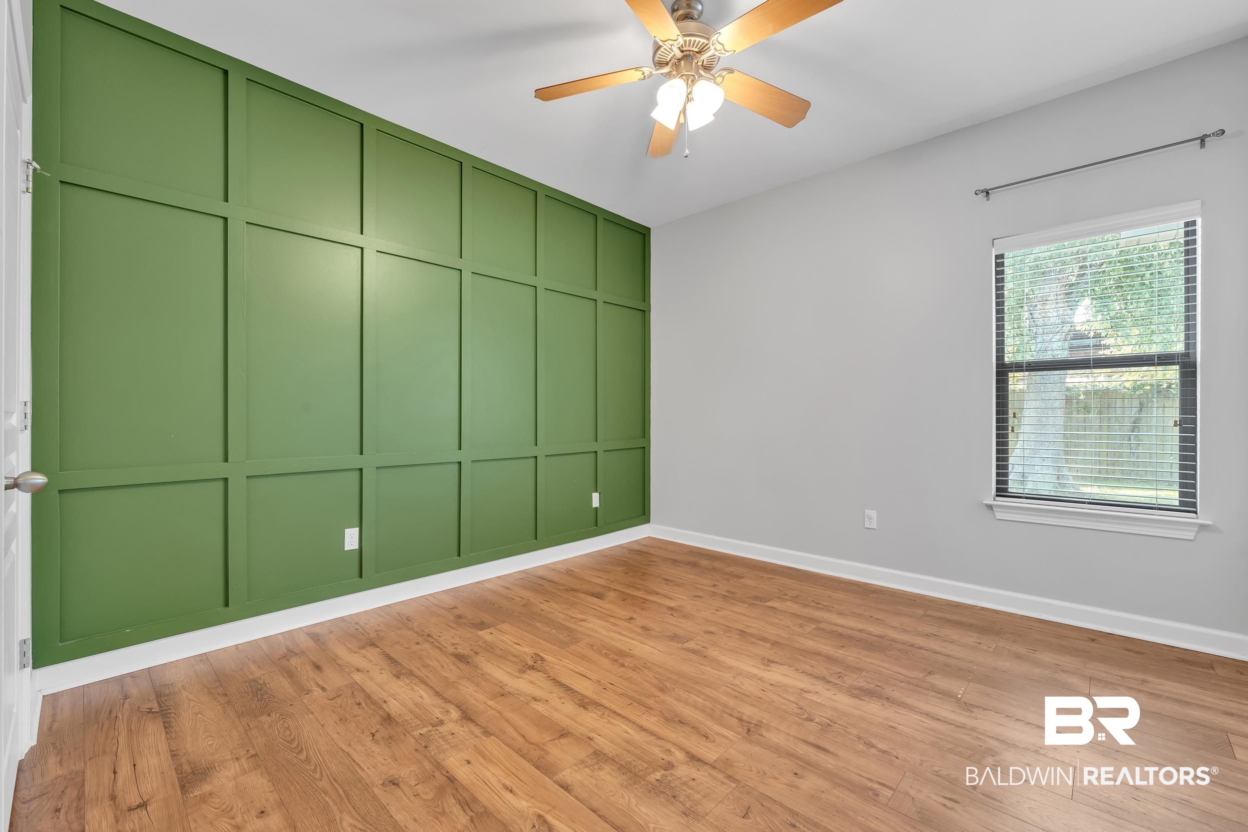 9508 Collier Loop Daphne, AL 36526 - Photo 27 of 29 Empty room with baseboards, light wood finished floors, ceiling fan, and a decorative wall