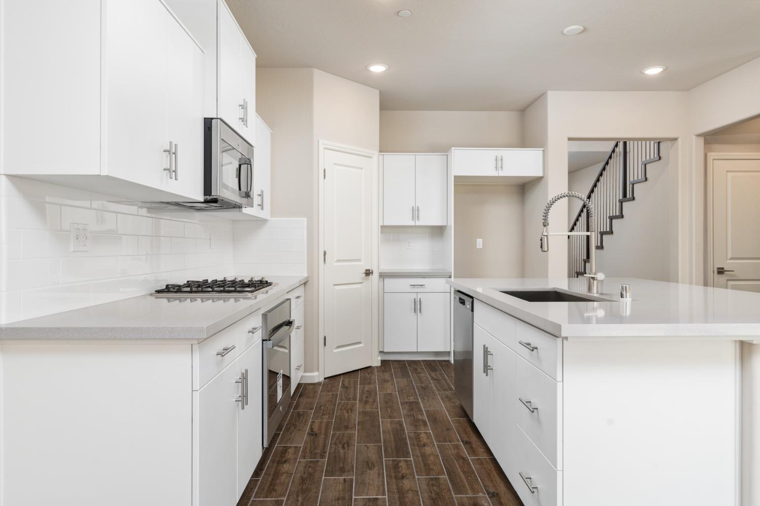 600 Traverse Drive Madera, CA 93636 - Photo 12 of 31 a kitchen with stainless steel appliances granite countertop a sink stove and refrigerator