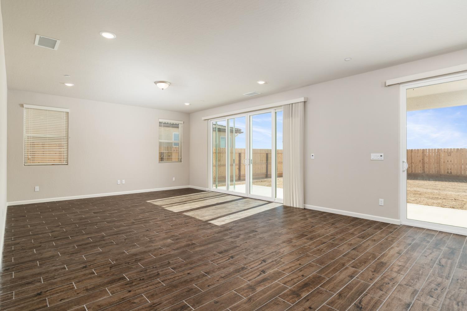 600 Traverse Drive Madera, CA 93636 - Photo 16 of 31 a view of an empty room with wooden floor and a window