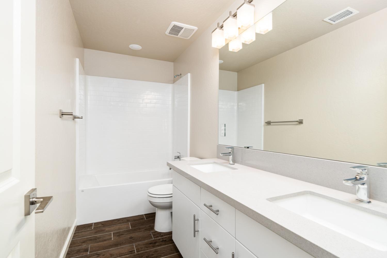 600 Traverse Drive Madera, CA 93636 - Photo 20 of 31 a bathroom with a double vanity sink mirror and toilet