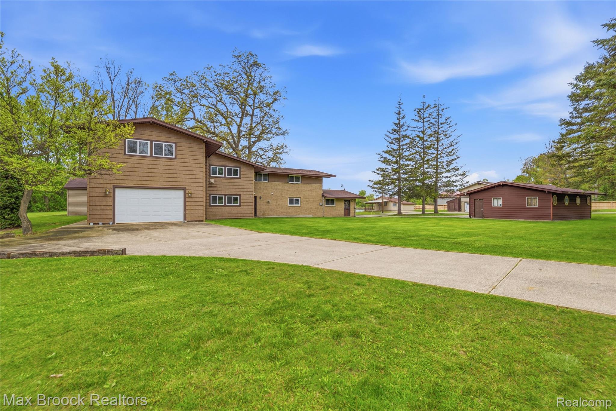 1392 Maple Grove Road Lapeer, MI 48446 - Photo 5 of 70 View of front of home with concrete driveway, a front lawn, and a garage