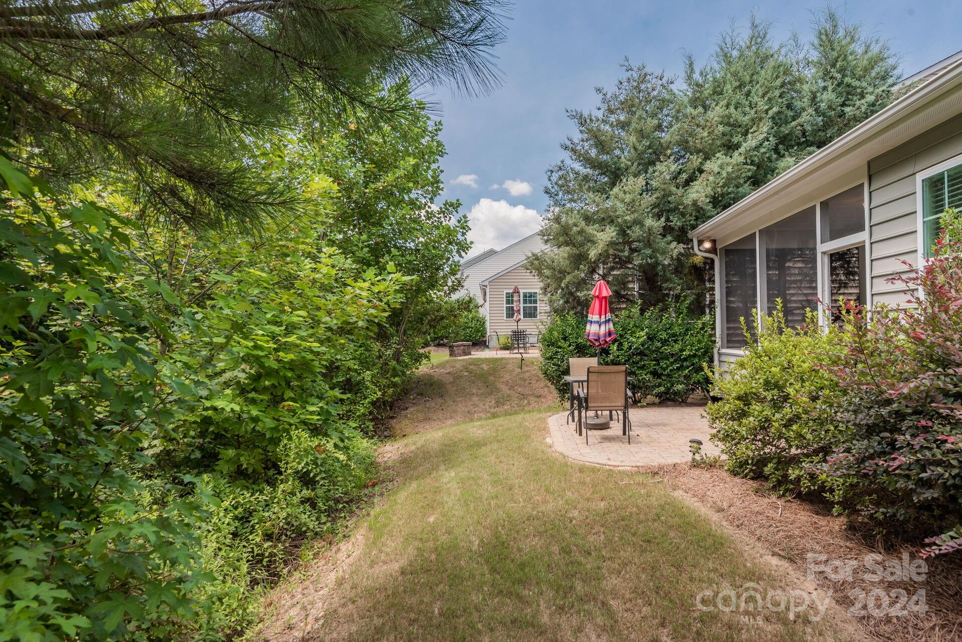 4325 Perth Road Indian Land, SC 29707 - Photo 25 of 33 a view of a chair and table in the back yard of the house