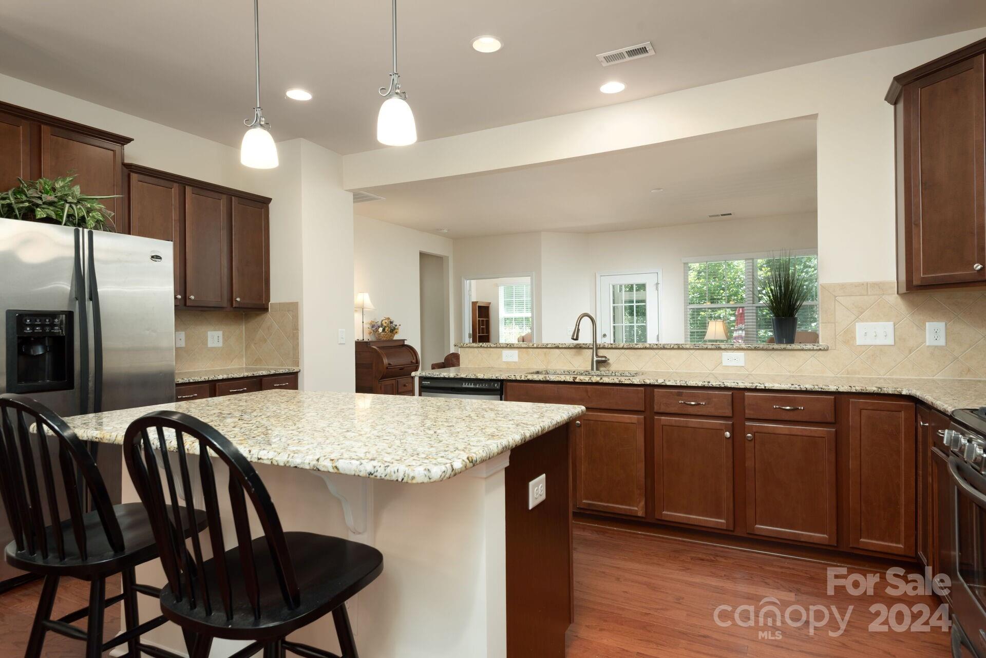 4325 Perth Road Indian Land, SC 29707 - Photo 6 of 33 a kitchen with a dining table chairs cabinets and stainless steel appliances
