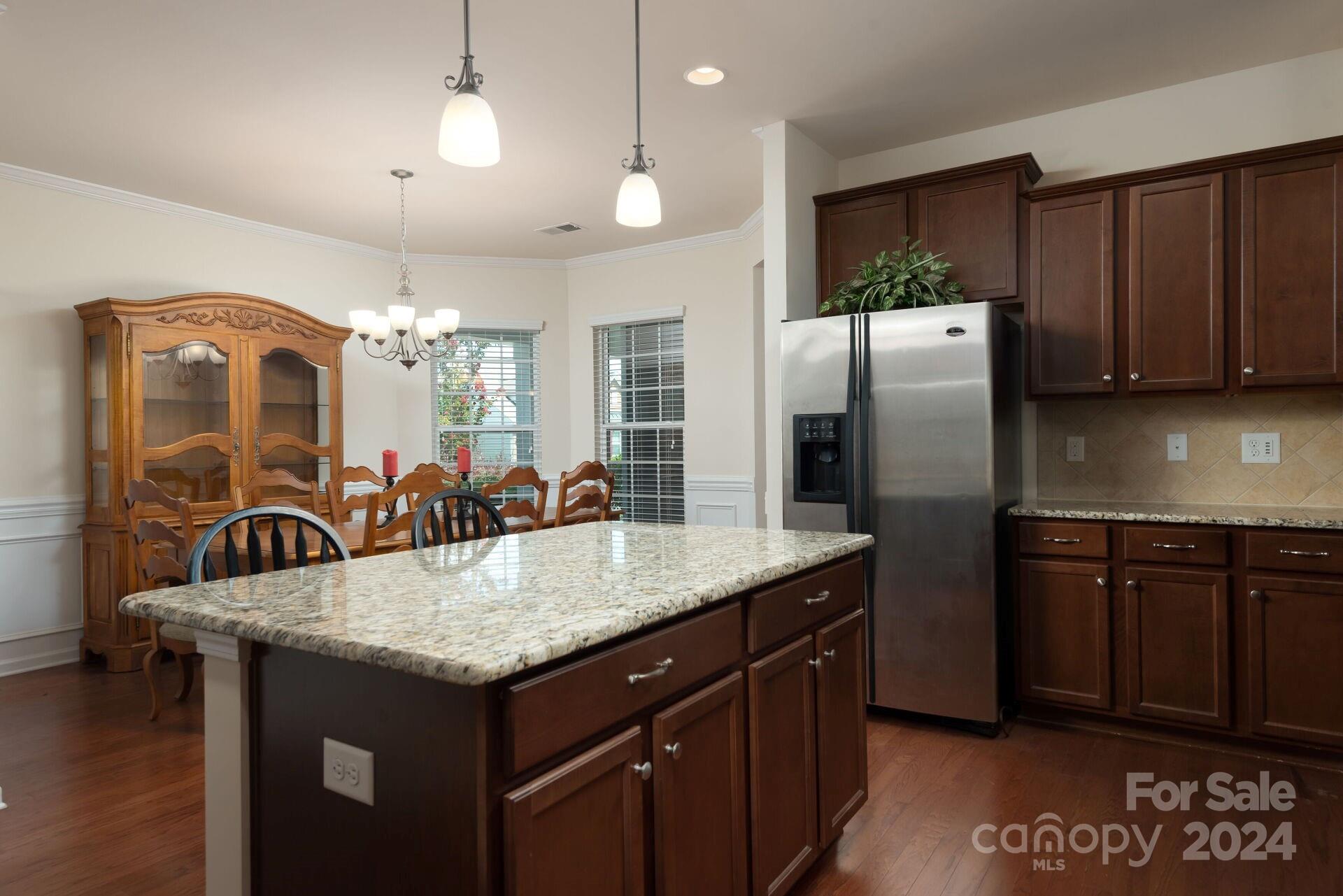 4325 Perth Road Indian Land, SC 29707 - Photo 7 of 33 a kitchen with granite countertop a center island and a refrigerator