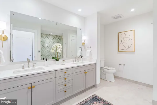 a view of a hallway with wooden floor and closet