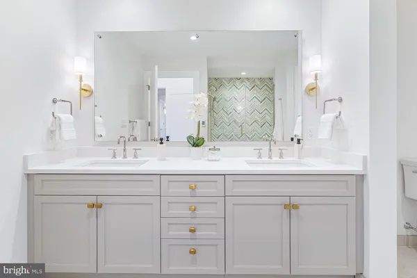 a bathroom with a sink a toilet and bathtub