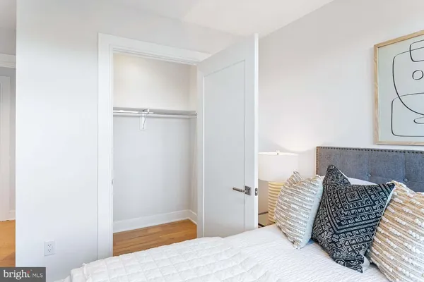 a living room with couches and kitchen view
