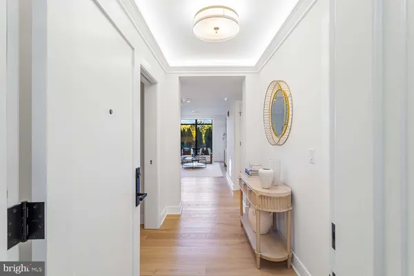 a living room with furniture flowerpot and wooden floor