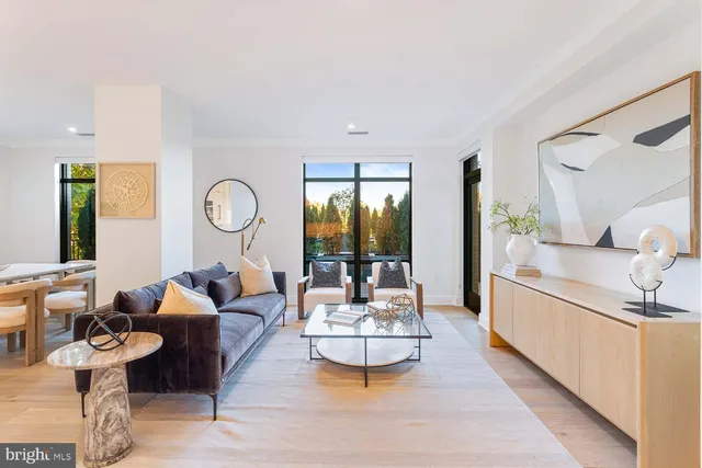 a dining room with furniture and a large window