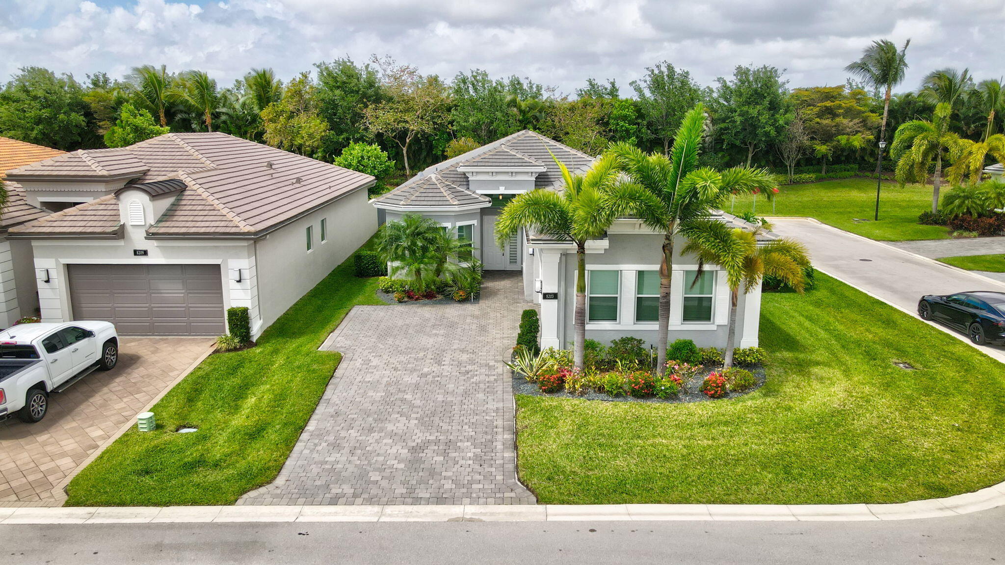 a aerial view of a house with a yard table and chairs