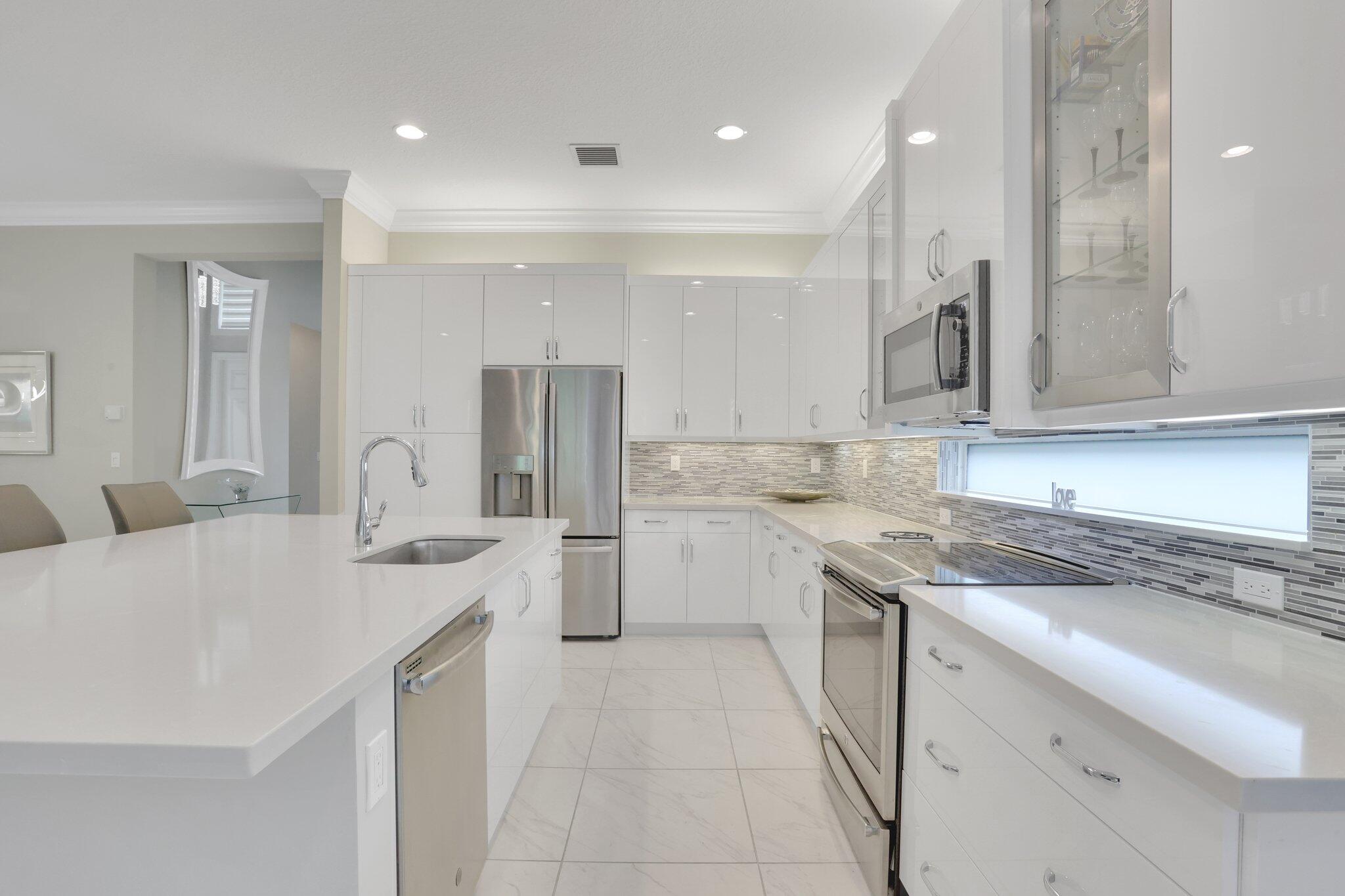 8203 Arabian Range Road Boynton Beach, FL 33473 - Photo 11 of 50 a kitchen with a sink stove and cabinets