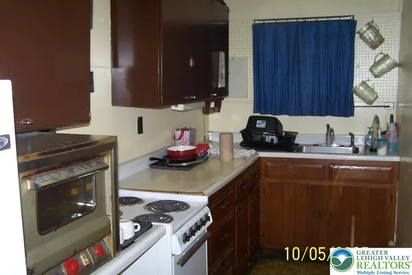 a kitchen with a cabinets and a stove top oven