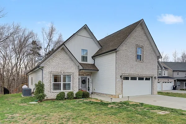 a front view of house with yard and green space