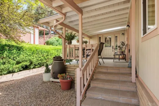 a view of a porch with potted plants