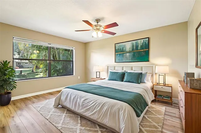 a bedroom with a large bed and a window