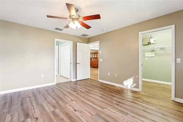 a view of an empty room and wooden floor