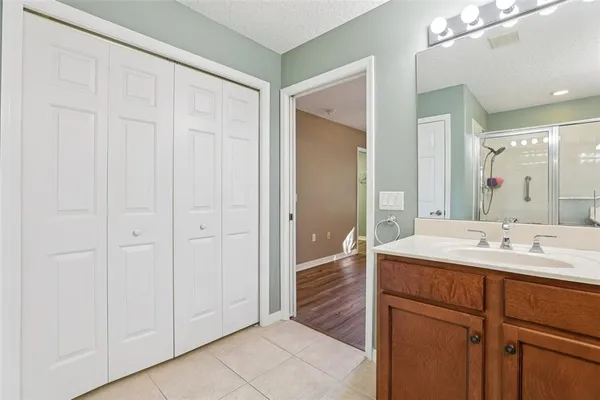 a bathroom with a double vanity sink and a mirror