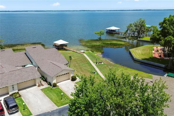 an aerial view of a house with a yard basket ball court