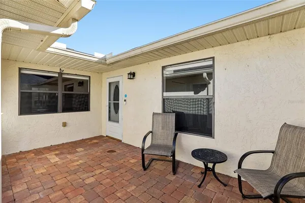 a view of house with backyard and sitting area