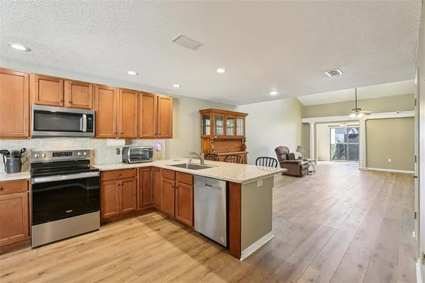 a kitchen with a sink cabinets and wooden floor