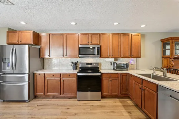 a kitchen with a sink a stove and refrigerator
