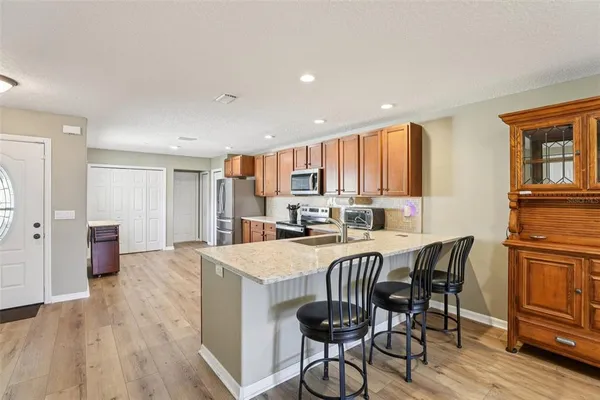 a view of a dining room with furniture and wooden floor