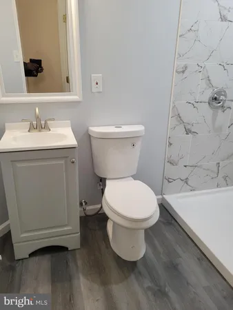 a white toilet sitting next to a bathroom sink