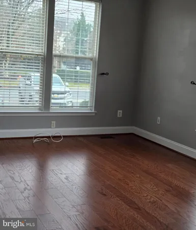 a view of a room with wooden floor and a window