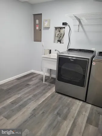 a utility room with a sink and a stove