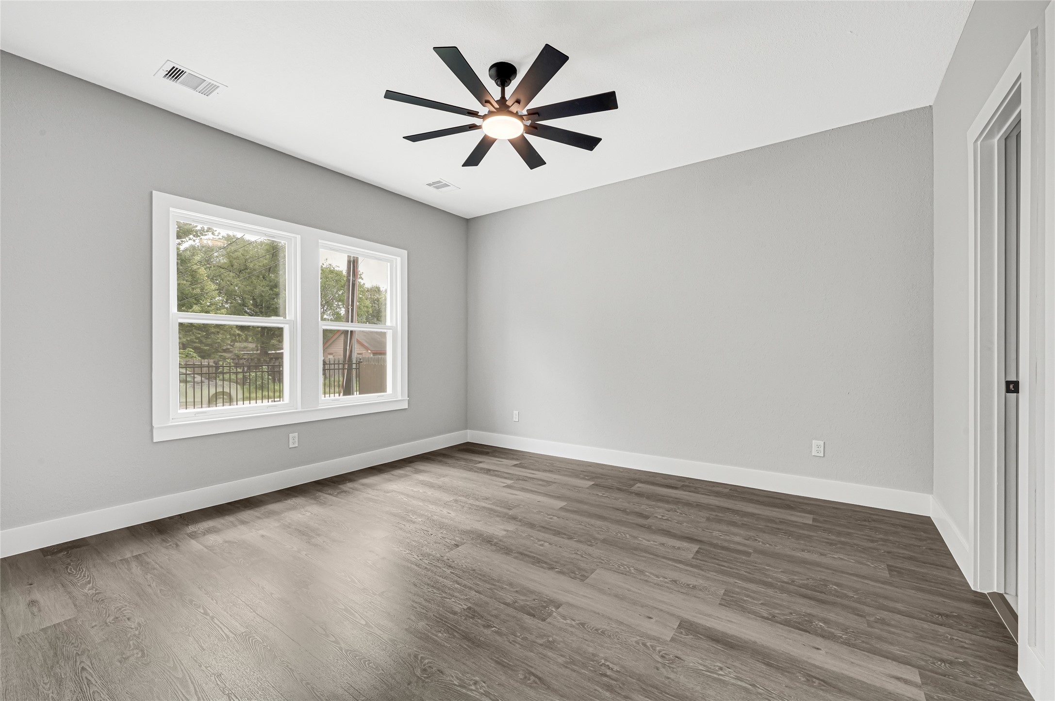 5930 Boness Road, Unit A & B Houston, TX 77396 - Photo 22 of 43 Spacious master bedroom with large windows and modern ceiling fan.