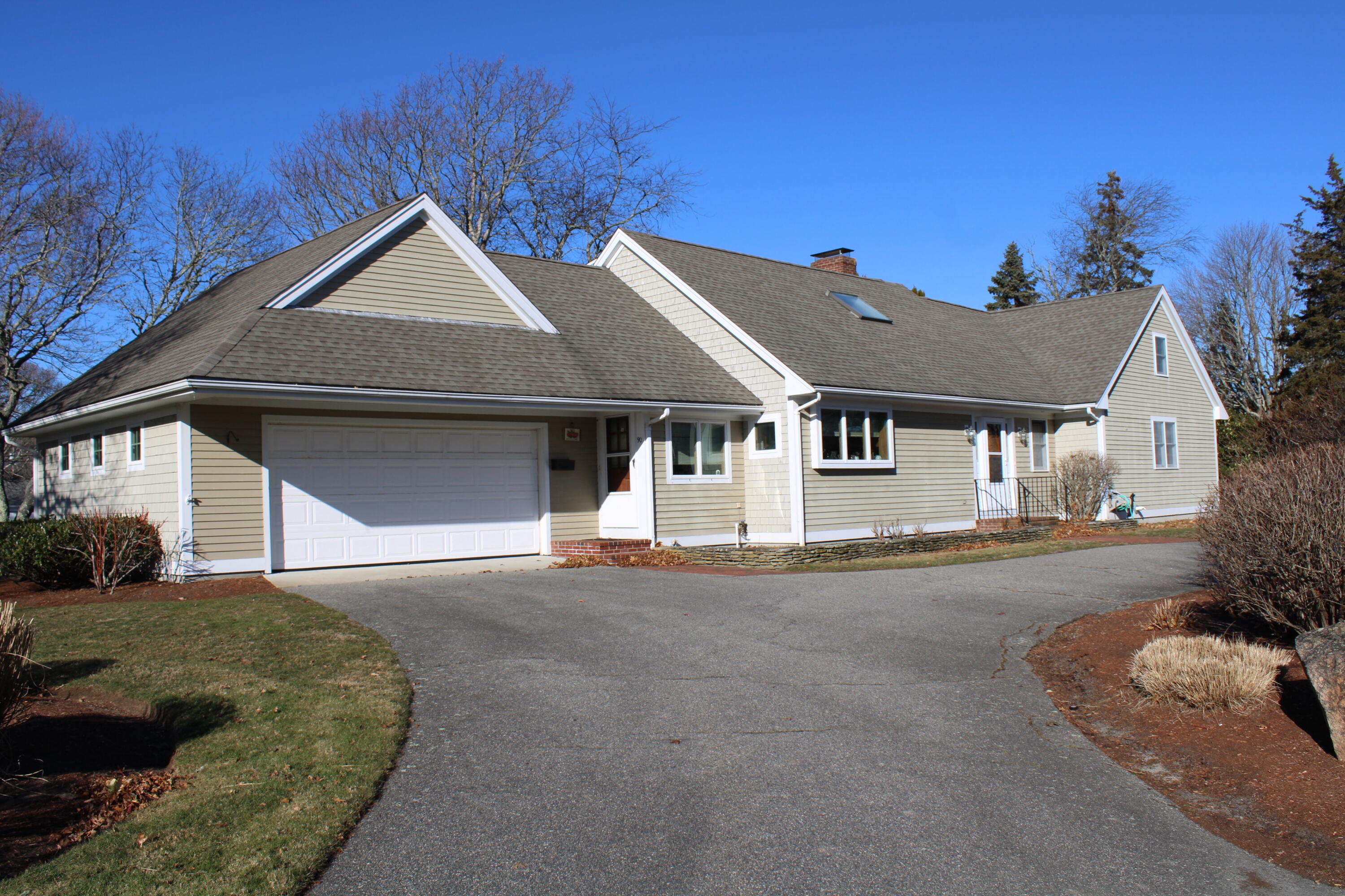 90 Swing Lane Falmouth, MA 02540 - Photo 1 of 43 a front view of a house with a yard and garage