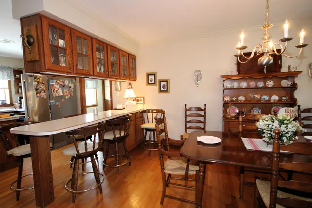 a view of a dining room with furniture and chandelier