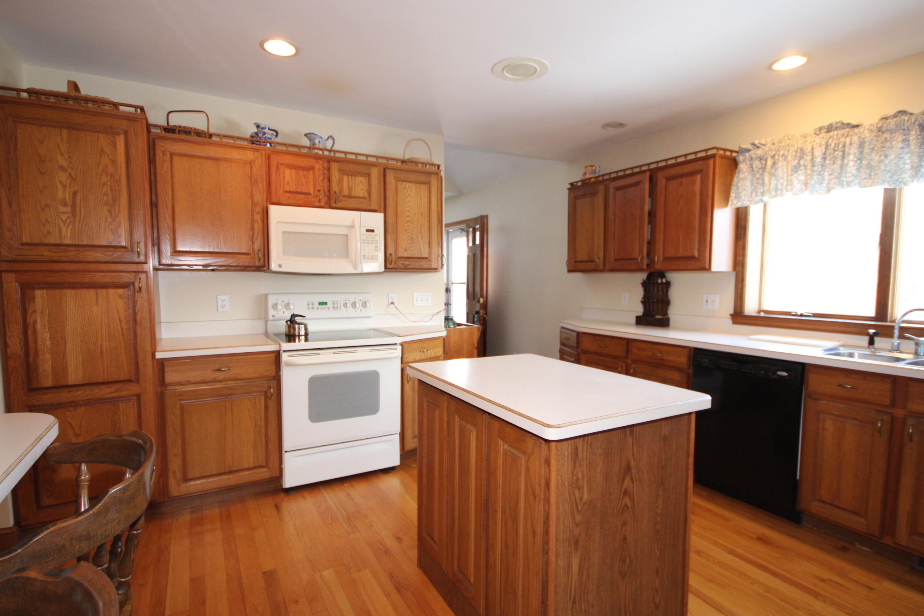 90 Swing Lane Falmouth, MA 02540 - Photo 20 of 43 a kitchen with stainless steel appliances granite countertop a sink stove and refrigerator