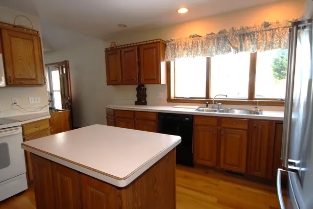 a kitchen with a sink a window and appliances