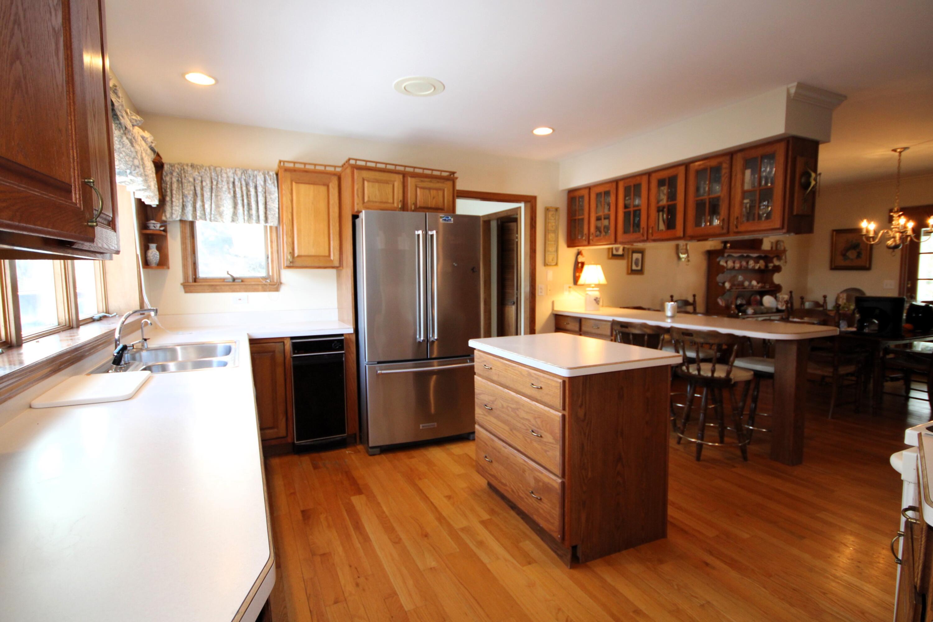 90 Swing Lane Falmouth, MA 02540 - Photo 22 of 43 a kitchen with a refrigerator and a sink