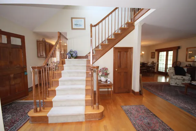 a view of entryway and hall with wooden floor