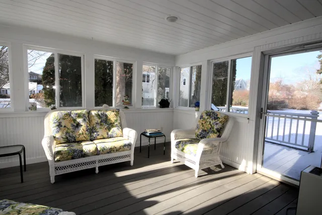 a living room with furniture and large windows