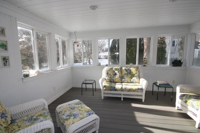 a living room with furniture and a floor to ceiling window