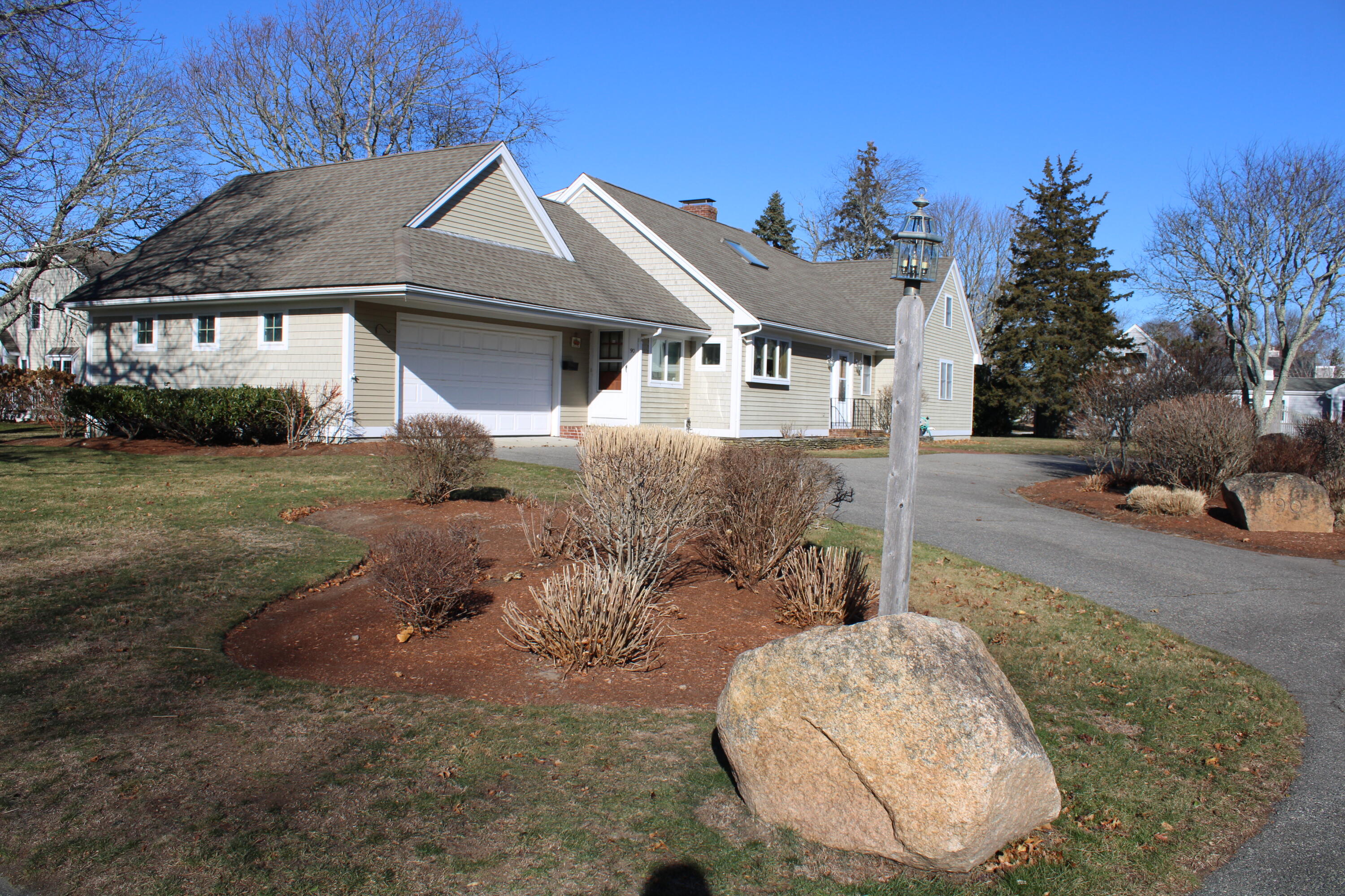 90 Swing Lane Falmouth, MA 02540 - Photo 4 of 43 a front view of a house with a yard