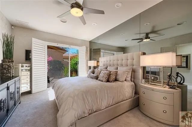 a bedroom with a large bed and a chandelier