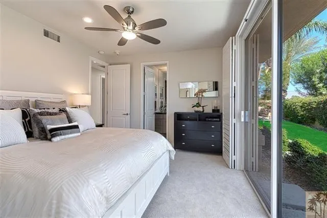 a bedroom with a bed and a large window