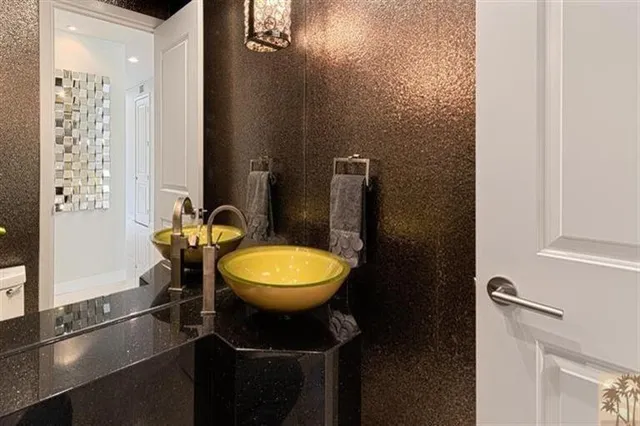 a bathroom with a sink a toilet a mirror and shower