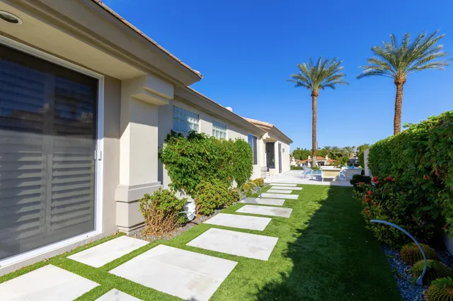 a front view of a house with garden