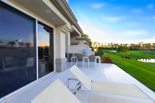 a swimming pool with outdoor seating and garden