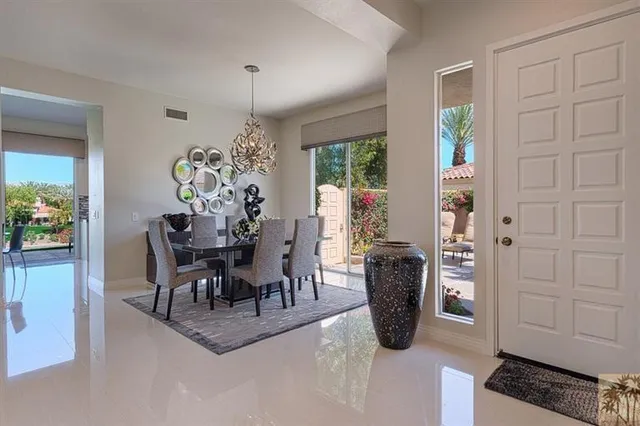 a dining room with furniture and a chandelier