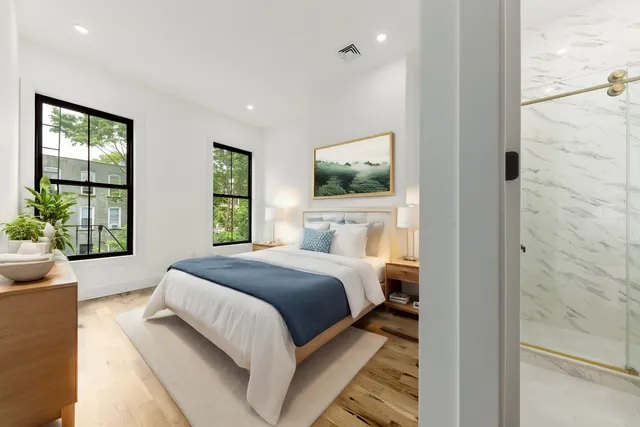 a bedroom with a large bed and a flat screen tv