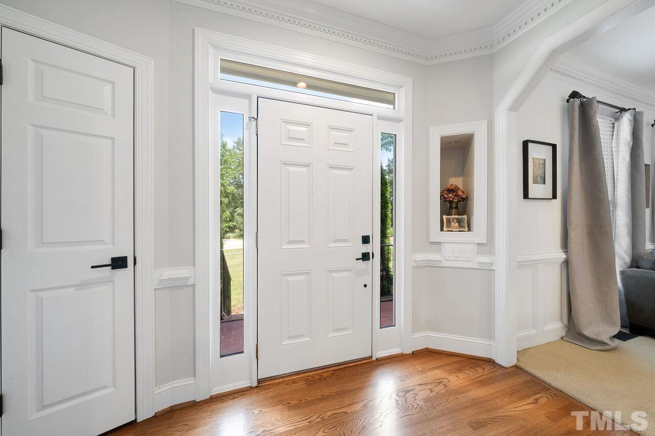 5533 Overleaf Court Raleigh, NC 27615 - Photo 3 of 32 an empty room with wooden floor closet and windows